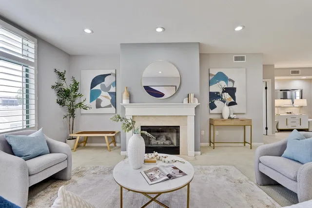 a living room with furniture and a fireplace