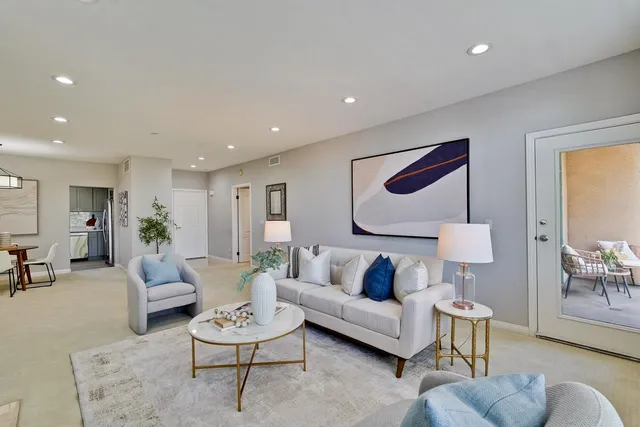 a view of a room with furniture and windows