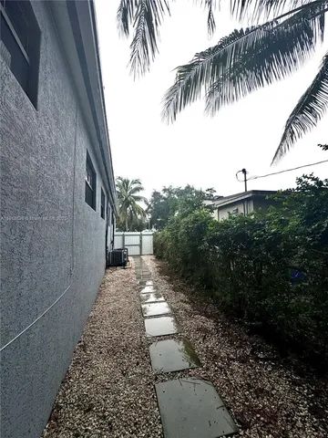 a view of a yard with potted plants