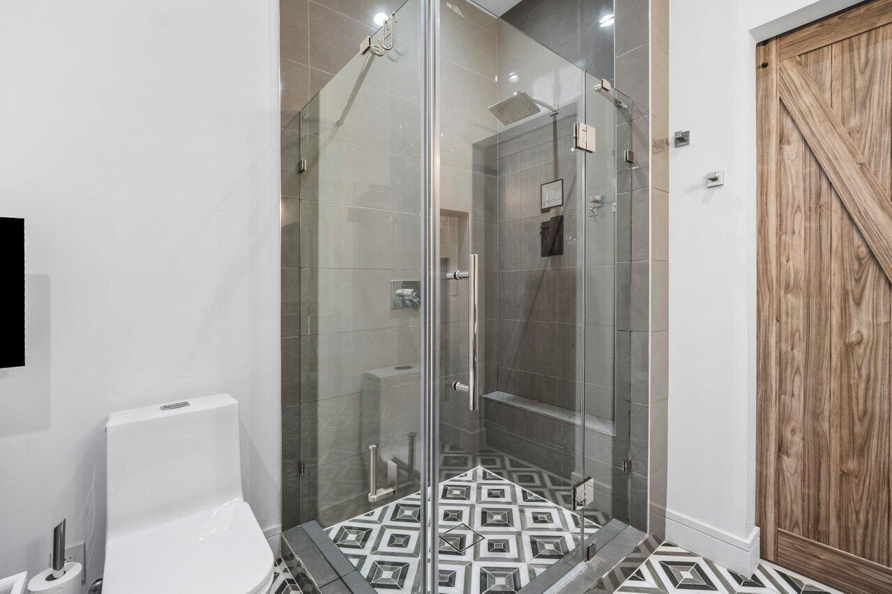 308 Enfield Road Delray Beach, FL 33444 - Photo 14 of 25 a bathroom with a toilet and a shower