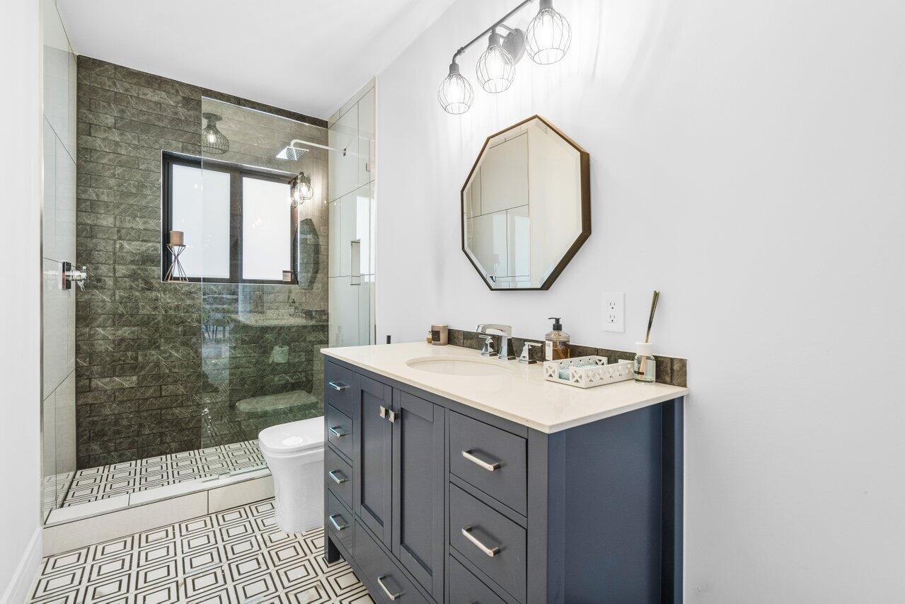 308 Enfield Road Delray Beach, FL 33444 - Photo 21 of 25 a bathroom with a sink a toilet and shower