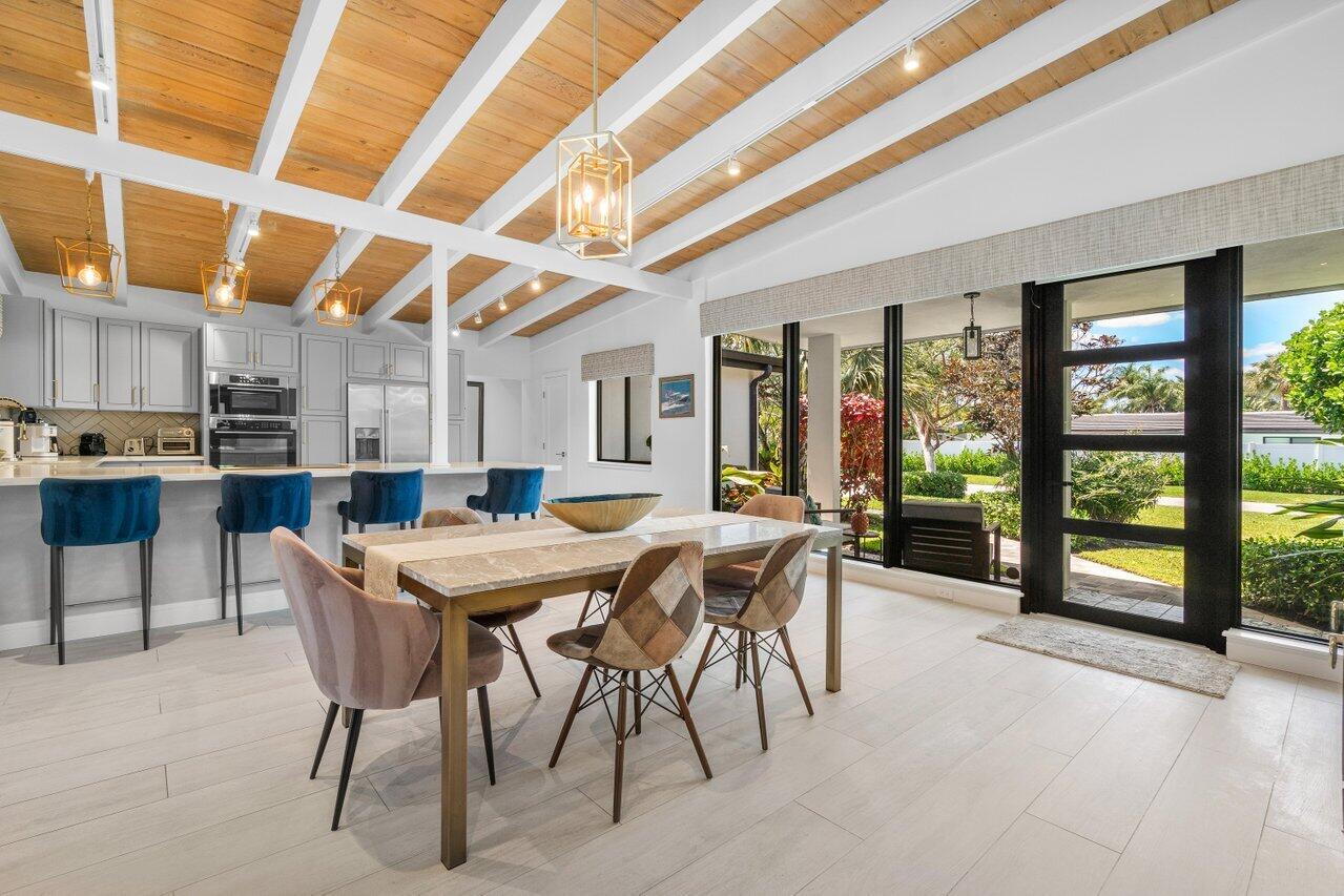 308 Enfield Road Delray Beach, FL 33444 - Photo 5 of 25 a view of a dining room with furniture large windows and wooden floor