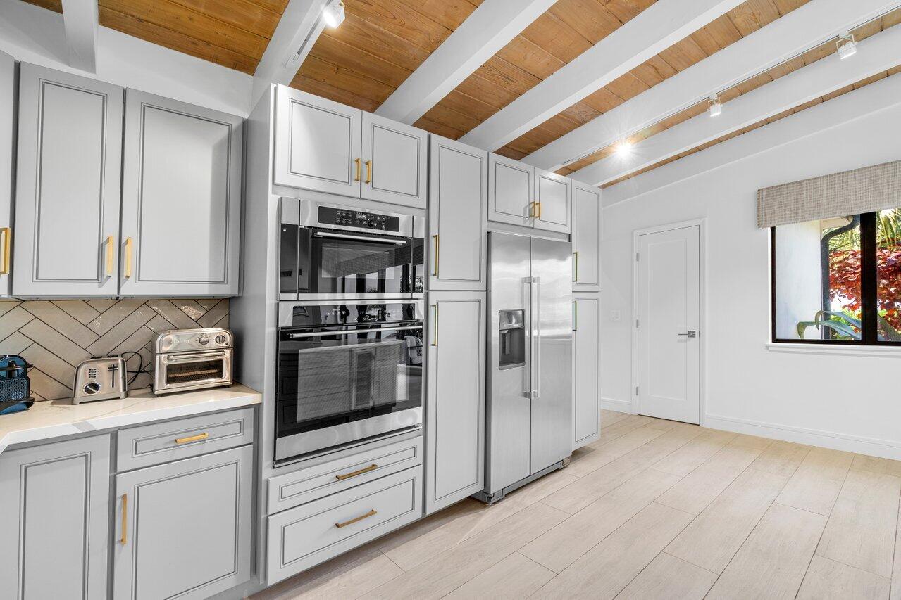 308 Enfield Road Delray Beach, FL 33444 - Photo 10 of 25 a kitchen with stainless steel appliances cabinets and a counter top space