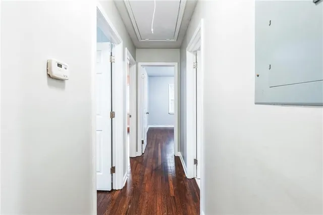 a view of a hallway with wooden floor