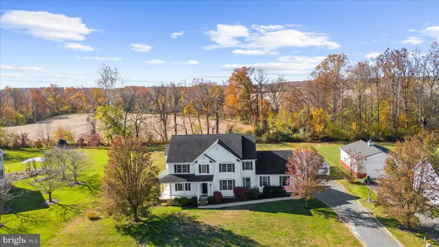 a front view of a house with a yard and lake view