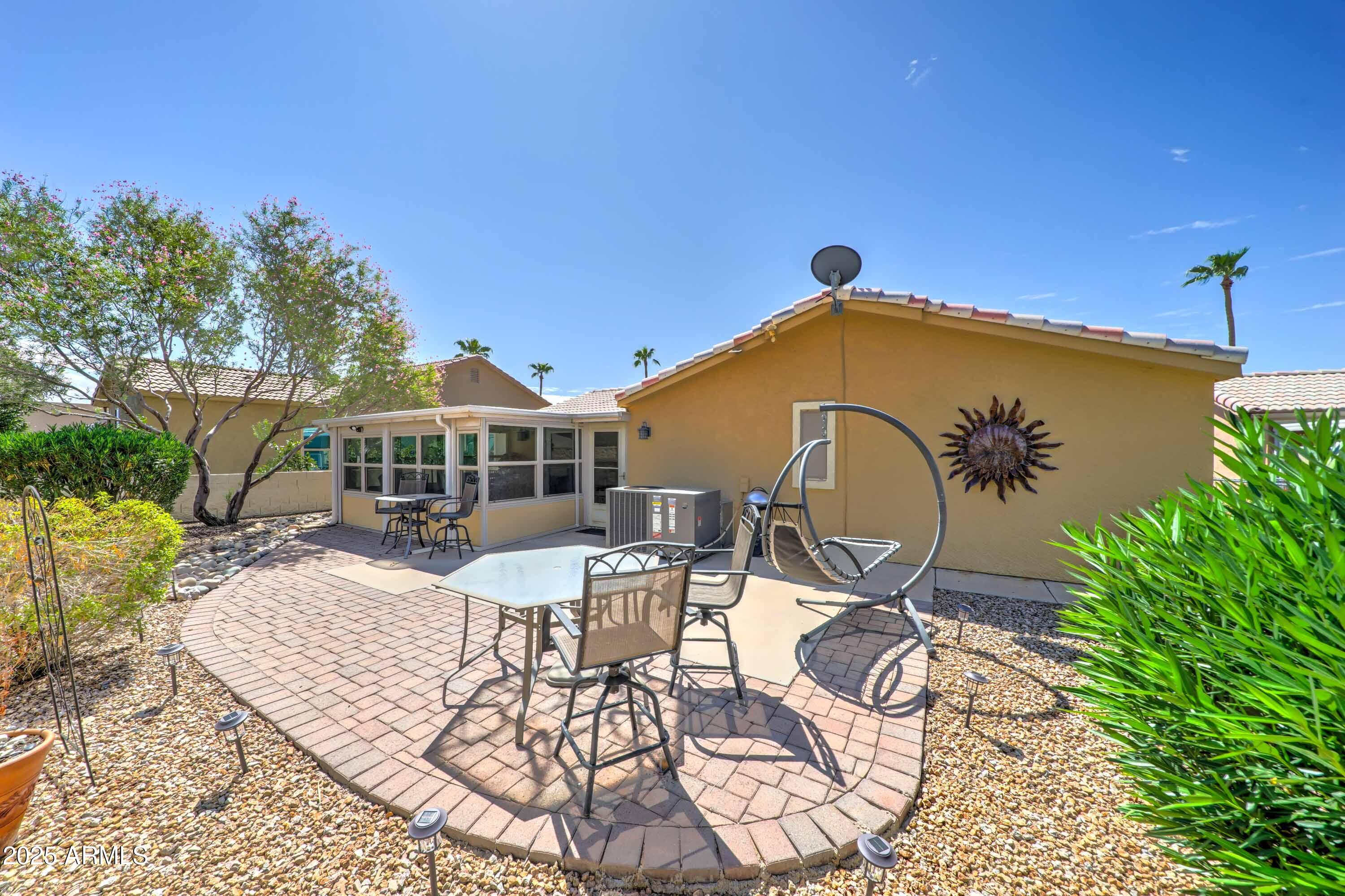 2101 South Meridian Road, Unit 72 Apache Junction, AZ 85120 - Photo 24 of 55 a view of a patio with table and chairs with a barbeque grill and plants