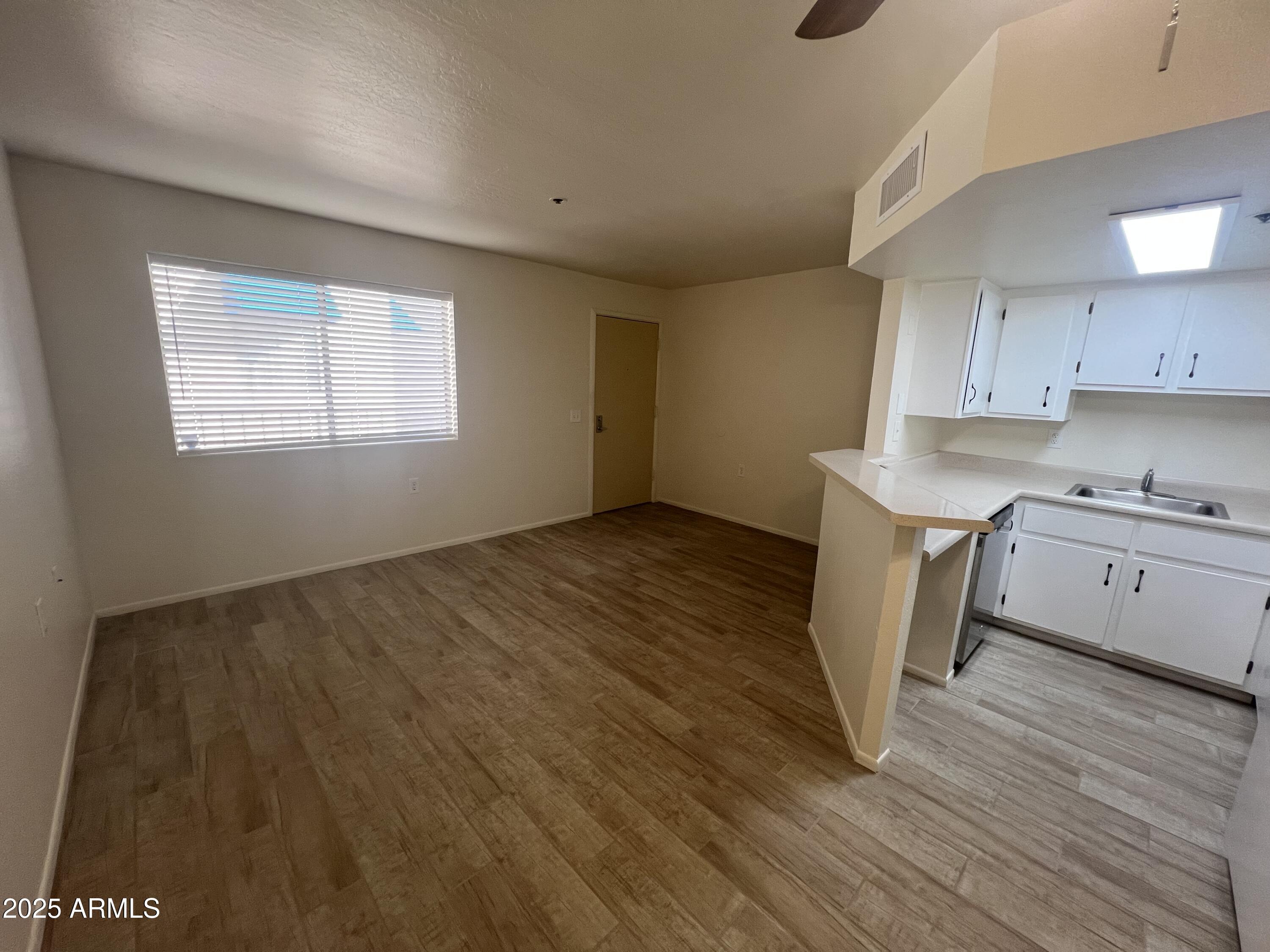 12221 West Bell Road, Unit 278 Surprise, AZ 85378 - Photo 11 of 24 a view of a kitchen with wooden floor