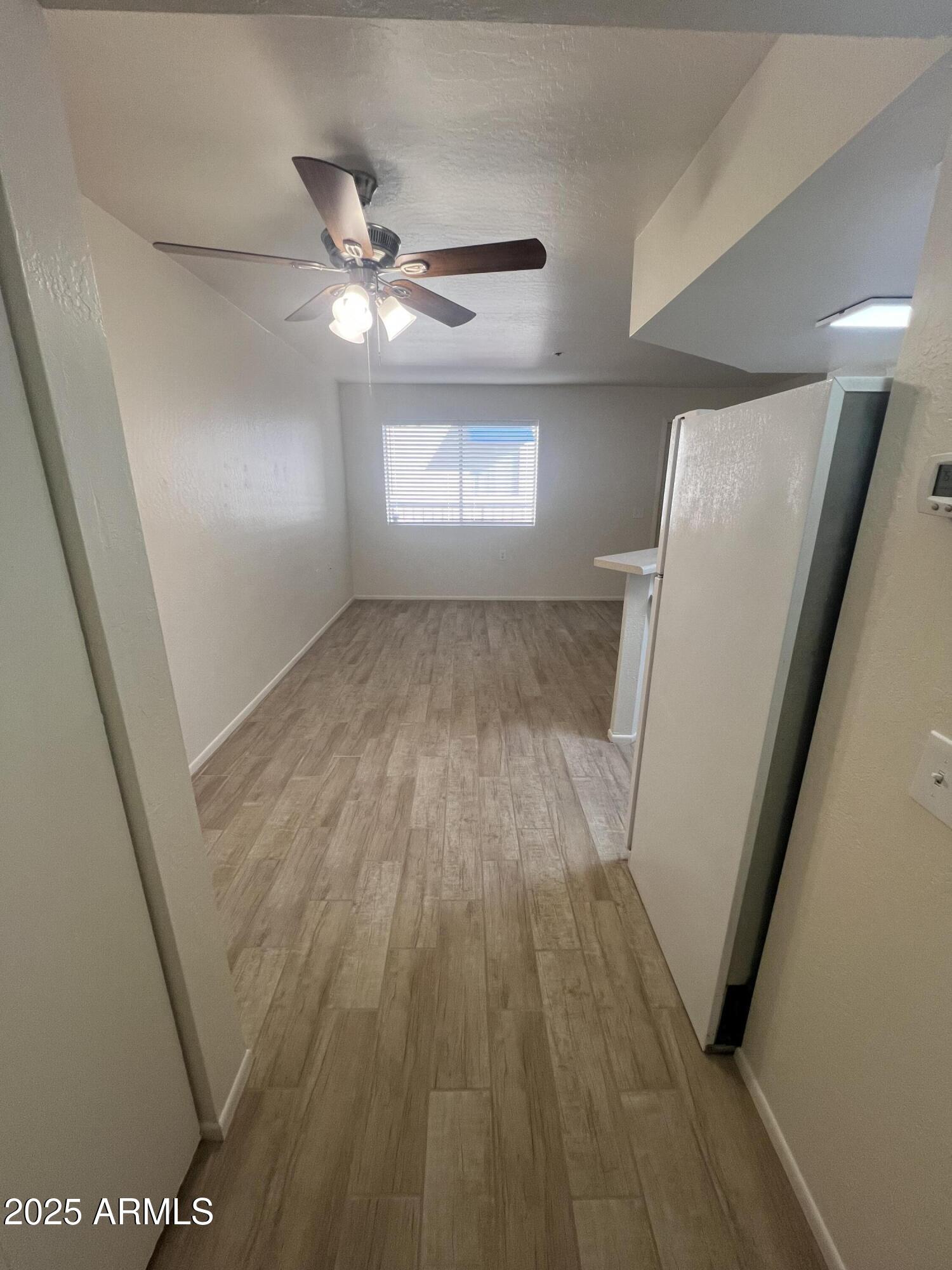12221 West Bell Road, Unit 278 Surprise, AZ 85378 - Photo 12 of 24 wooden floor in an empty room with a window