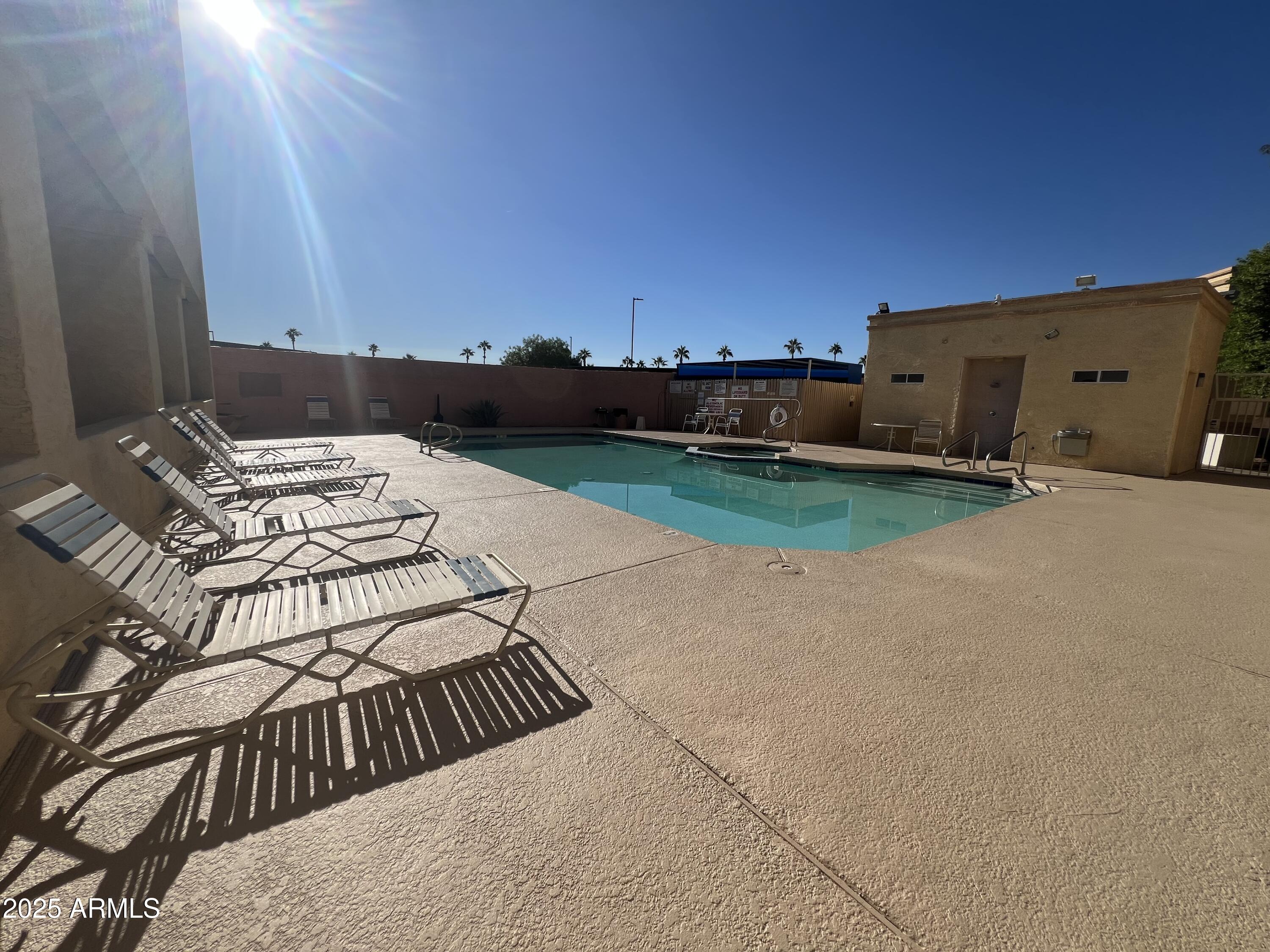 12221 West Bell Road, Unit 278 Surprise, AZ 85378 - Photo 23 of 24 a view of a house with backyard and a chair