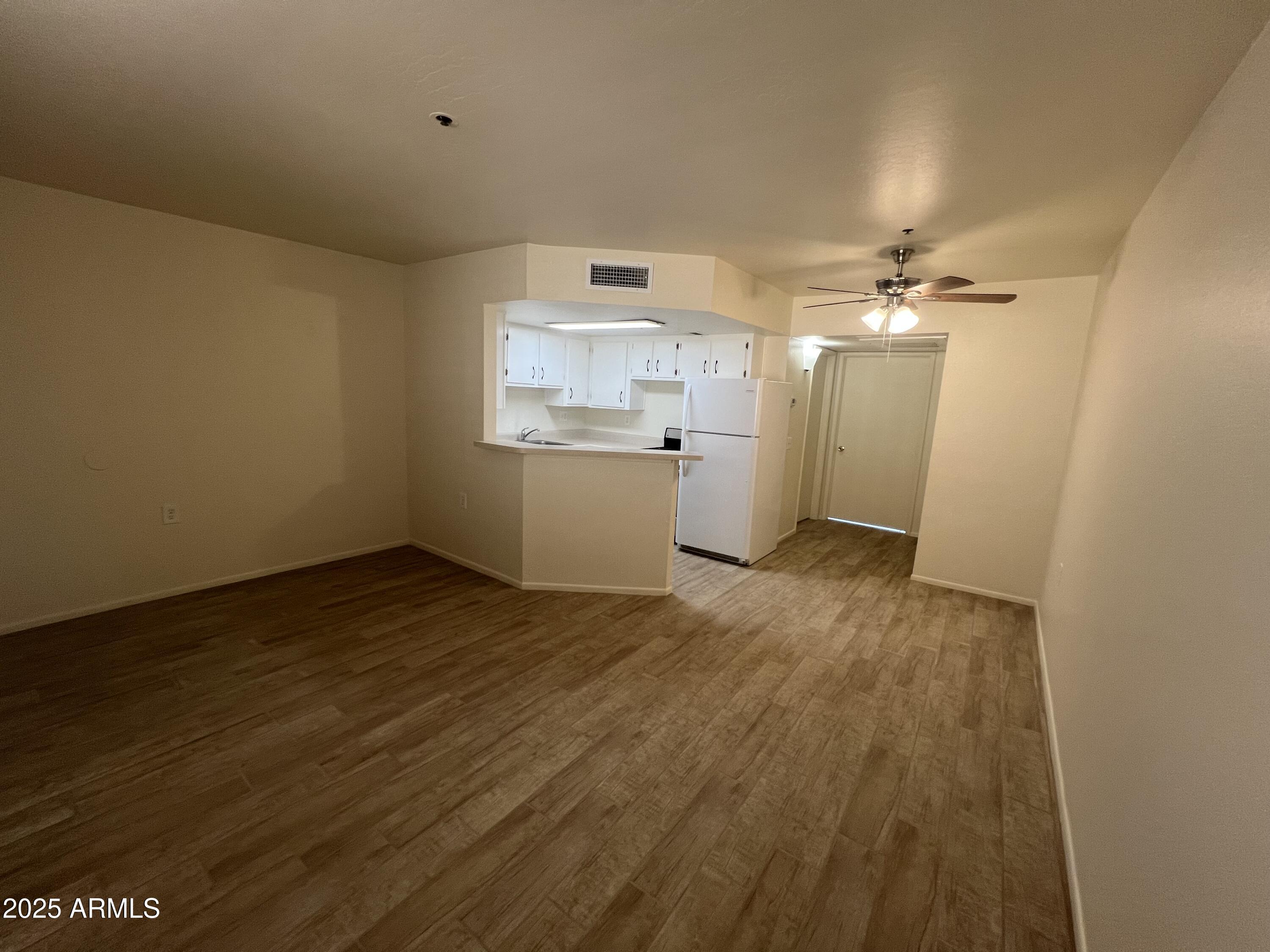 12221 West Bell Road, Unit 278 Surprise, AZ 85378 - Photo 5 of 24 a room with wooden floor and window