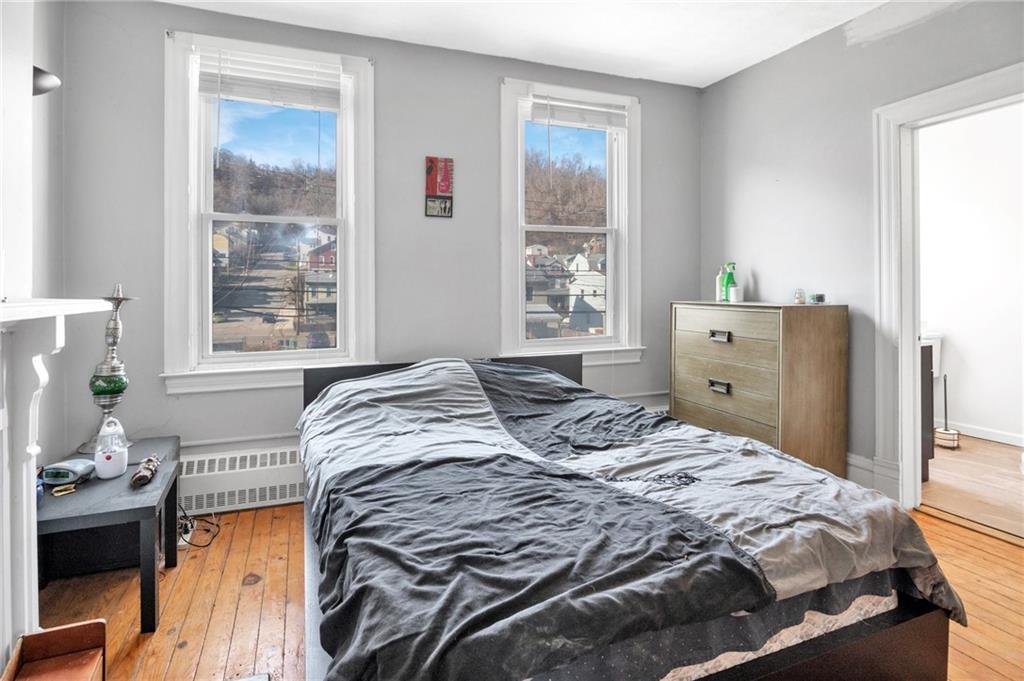 726 Evergreen Road Pittsburgh, PA 15209 - Photo 12 of 25 a bedroom with a bed and windows