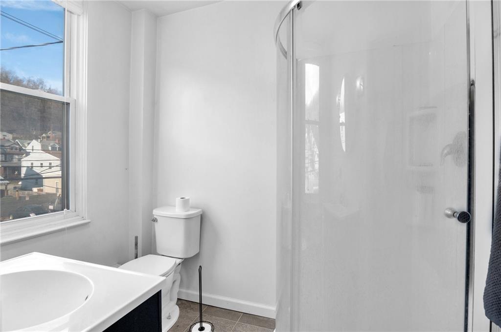 726 Evergreen Road Pittsburgh, PA 15209 - Photo 13 of 25 a bathroom with a sink a toilet and window