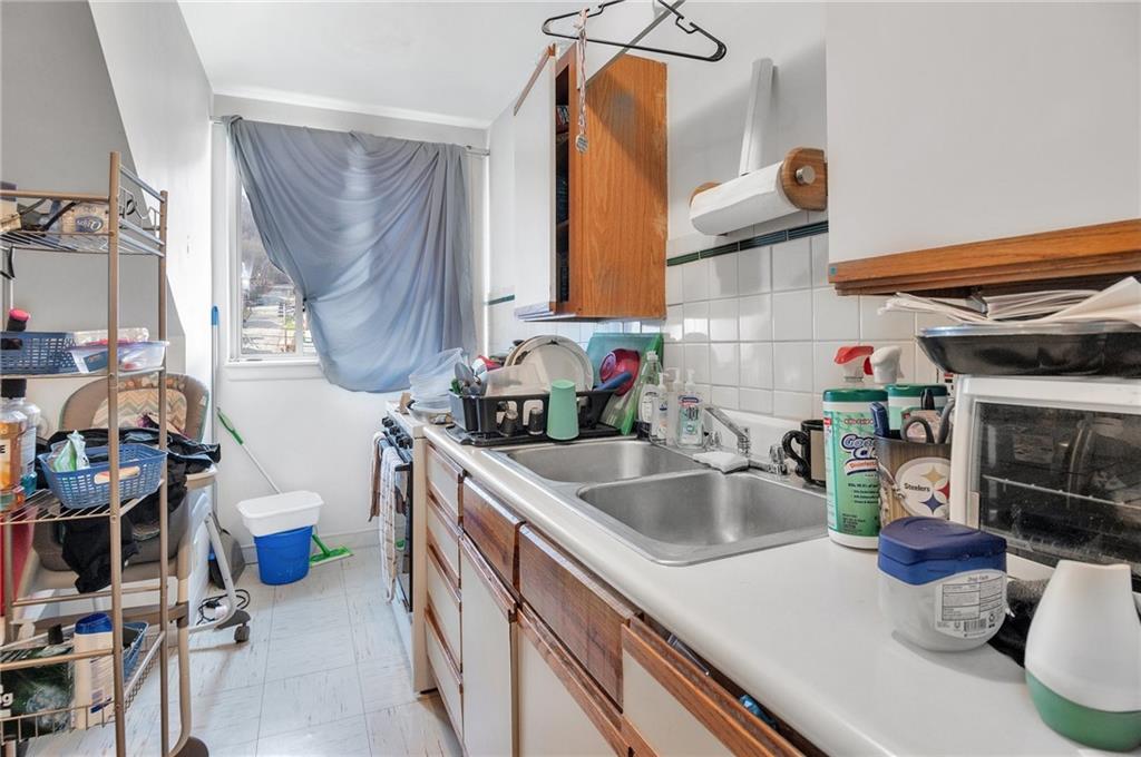 726 Evergreen Road Pittsburgh, PA 15209 - Photo 15 of 25 a kitchen with a sink and a stove top oven