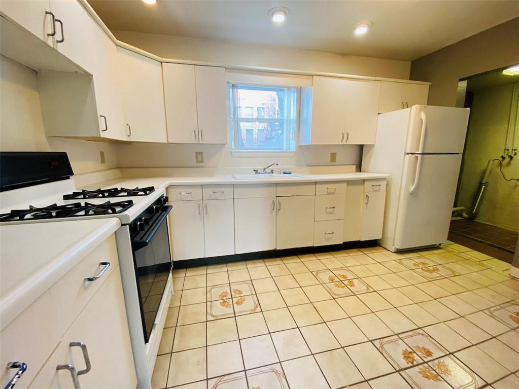 726 Evergreen Road Pittsburgh, PA 15209 - Photo 20 of 25 a kitchen with a sink a refrigerator and cabinets