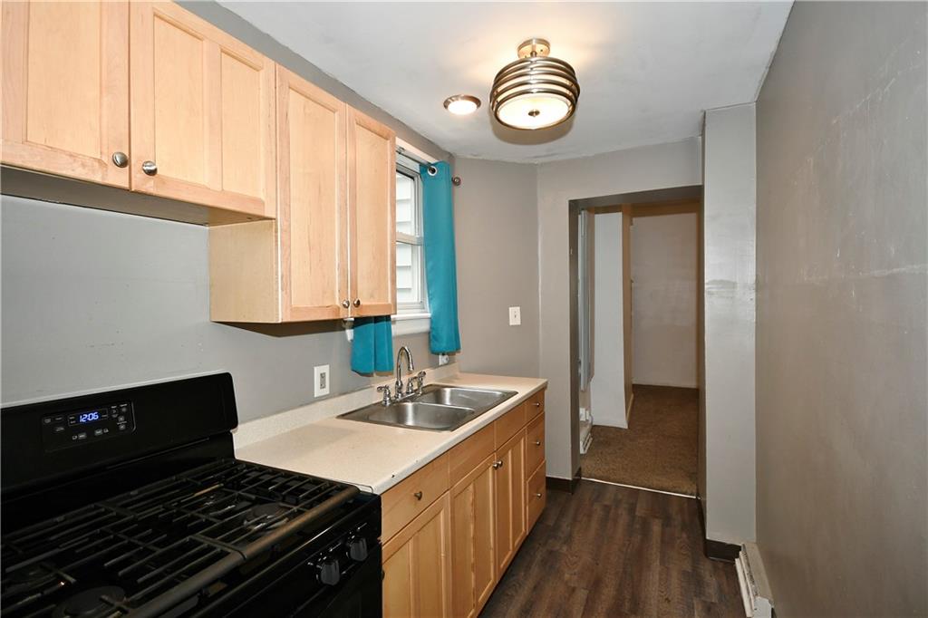 726 Evergreen Road Pittsburgh, PA 15209 - Photo 4 of 25 a kitchen with a sink stove and microwave