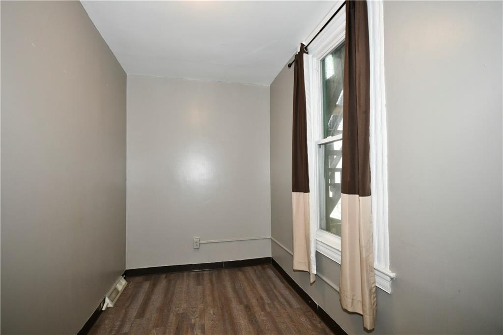 726 Evergreen Road Pittsburgh, PA 15209 - Photo 5 of 25 a view of an empty room with wooden floor and a window