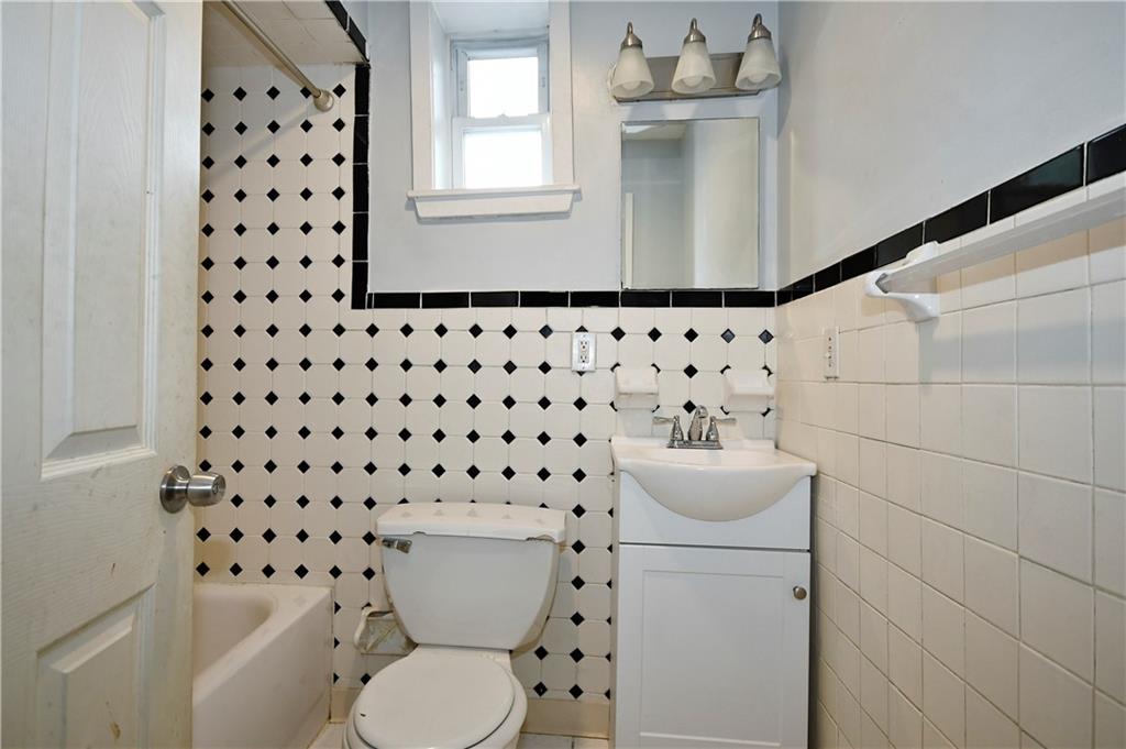 726 Evergreen Road Pittsburgh, PA 15209 - Photo 6 of 25 a bathroom with a sink a toilet and a mirror