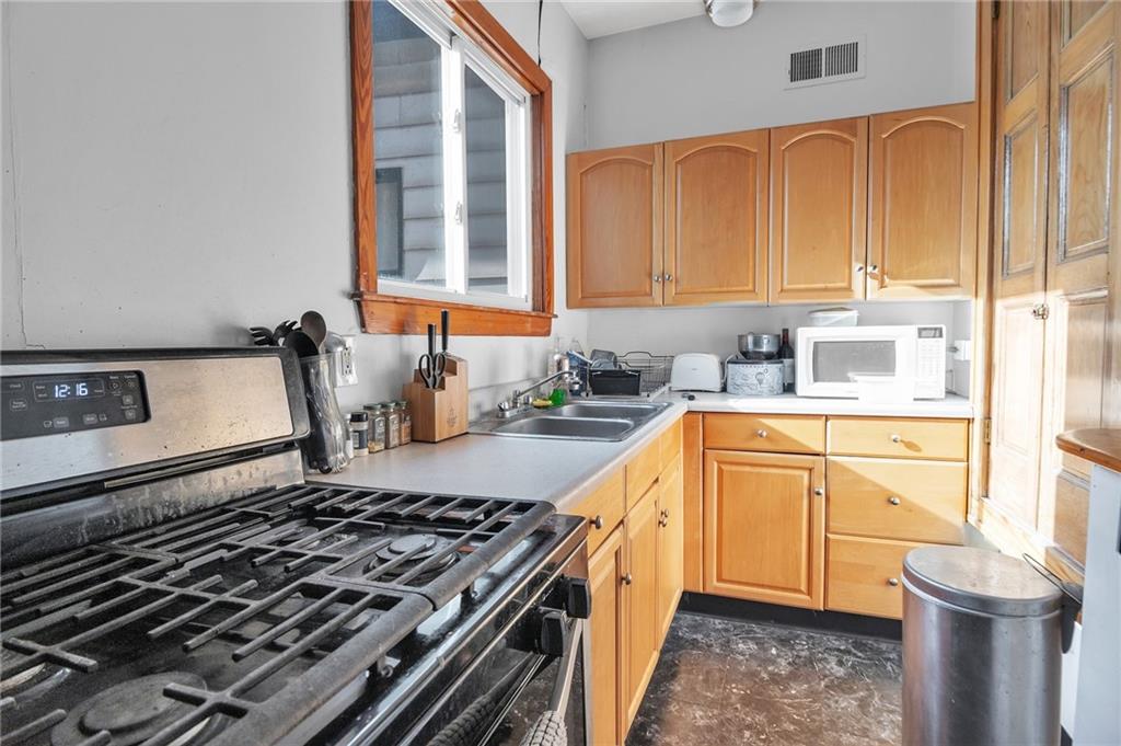 726 Evergreen Road Pittsburgh, PA 15209 - Photo 10 of 25 a kitchen with a sink stove and cabinets