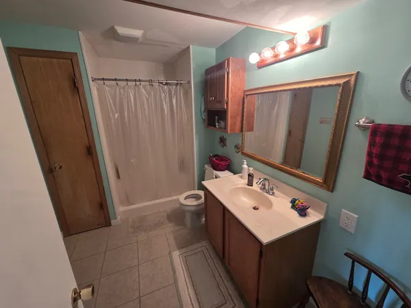 a bathroom with a sink a mirror and a shower