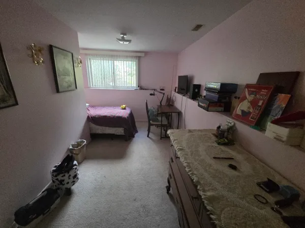 a bedroom with furniture and a window