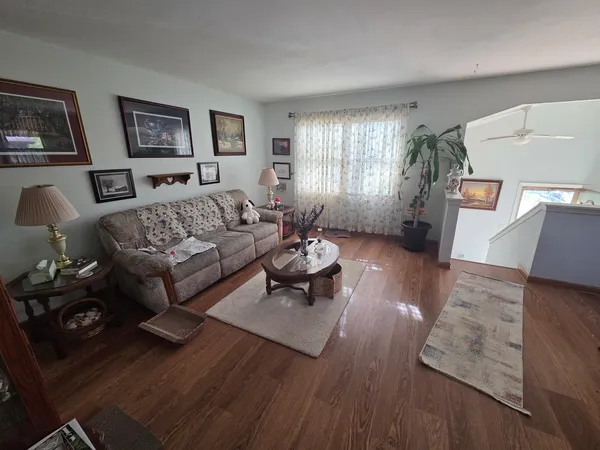 a living room with furniture and wooden floor
