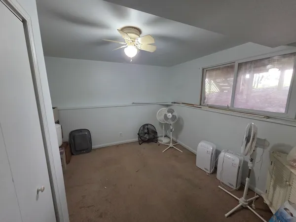 a view of a room with furniture and chandelier