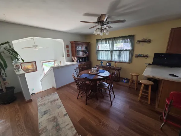 a view of a dining room with furniture and wooden floor