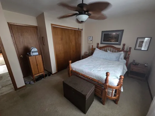 a bedroom with a bed and a flat tv screen on the wall