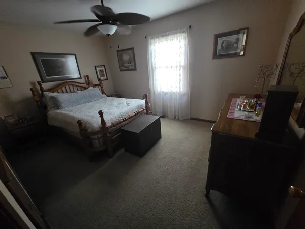 a bedroom with a bed furniture and a window