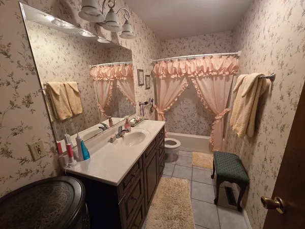 a bathroom with a sink vanity and a mirror