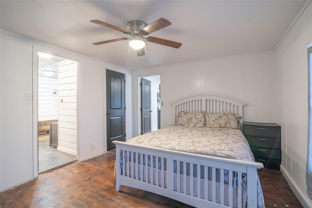 17540 Old George Drive Terrell, TX 75160 - Photo 19 of 28 a bedroom with a bed and a chandelier