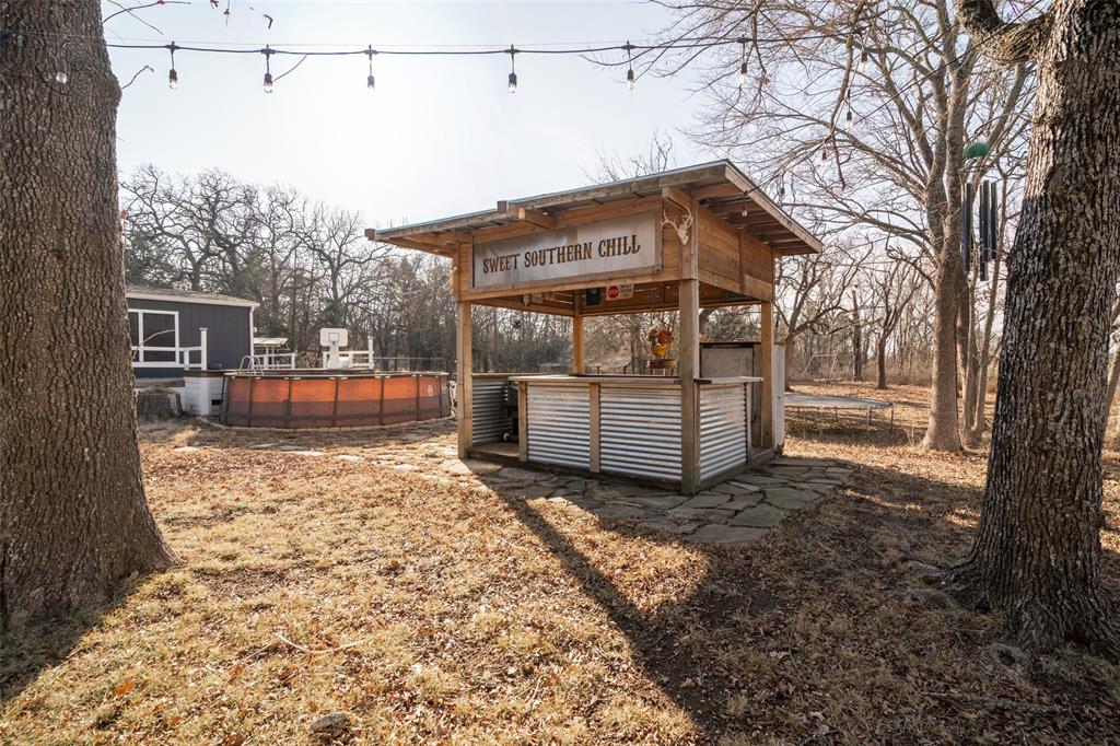 17540 Old George Drive Terrell, TX 75160 - Photo 24 of 28 a backyard of a house with oven and outdoor seating