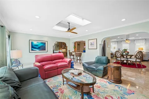 a living room with furniture a flat screen tv and a large window