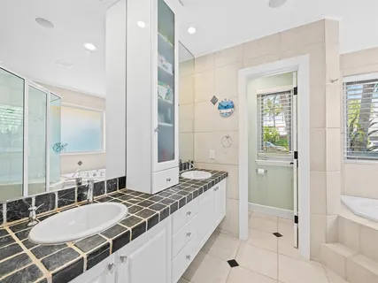 a bathroom with a tub shower and a sink