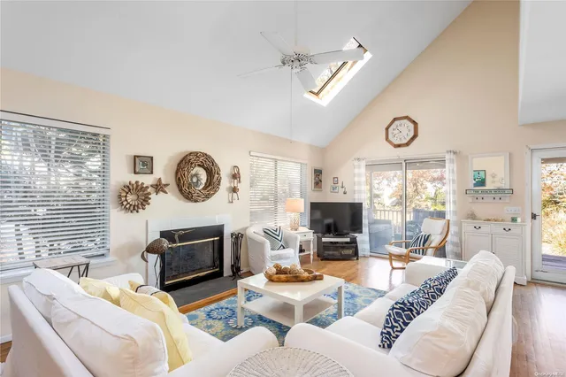 a living room with fireplace furniture and a large window