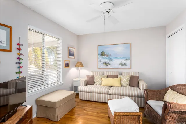 a bedroom with furniture and a large window