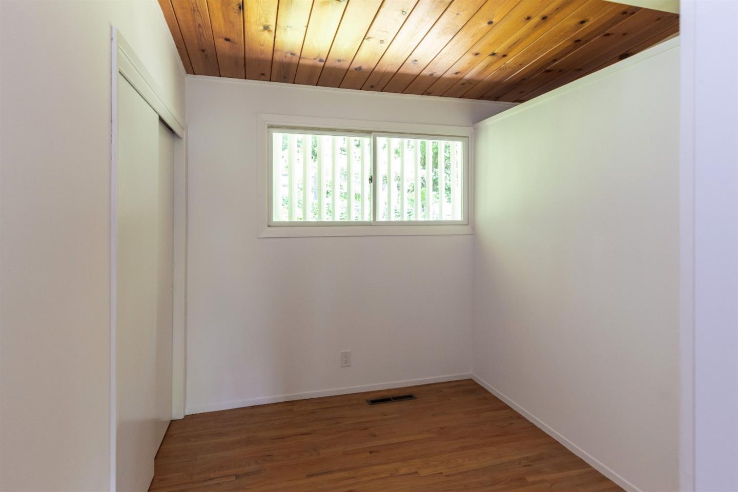 21661 Woolaroc Drive Los Gatos, CA 95033 - Photo 14 of 48 an empty room with wooden floor and windows