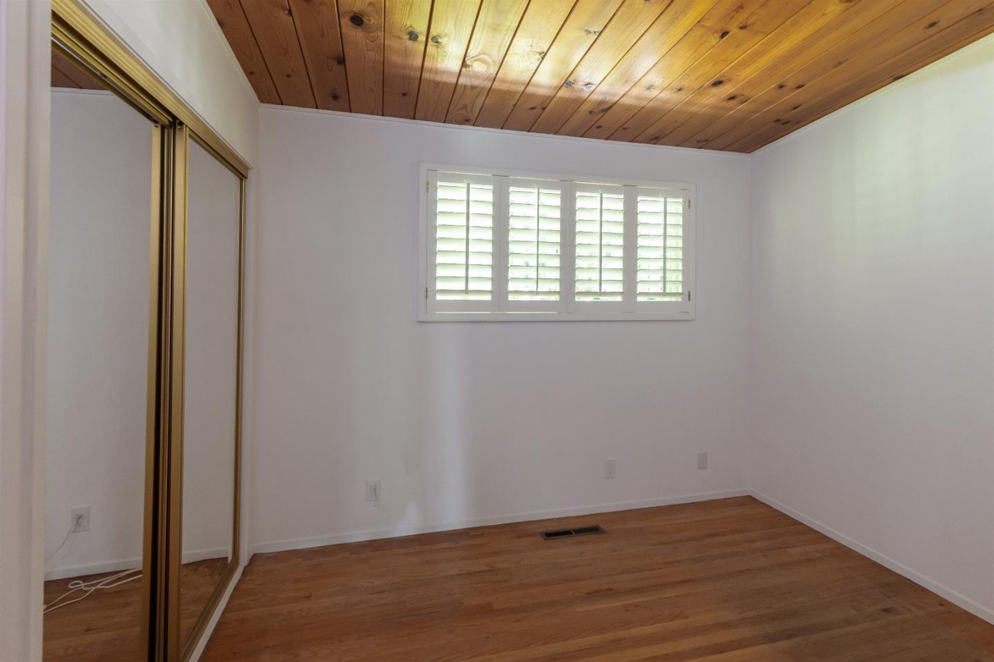 21661 Woolaroc Drive Los Gatos, CA 95033 - Photo 15 of 48 a view of an empty room with wooden floor and a window