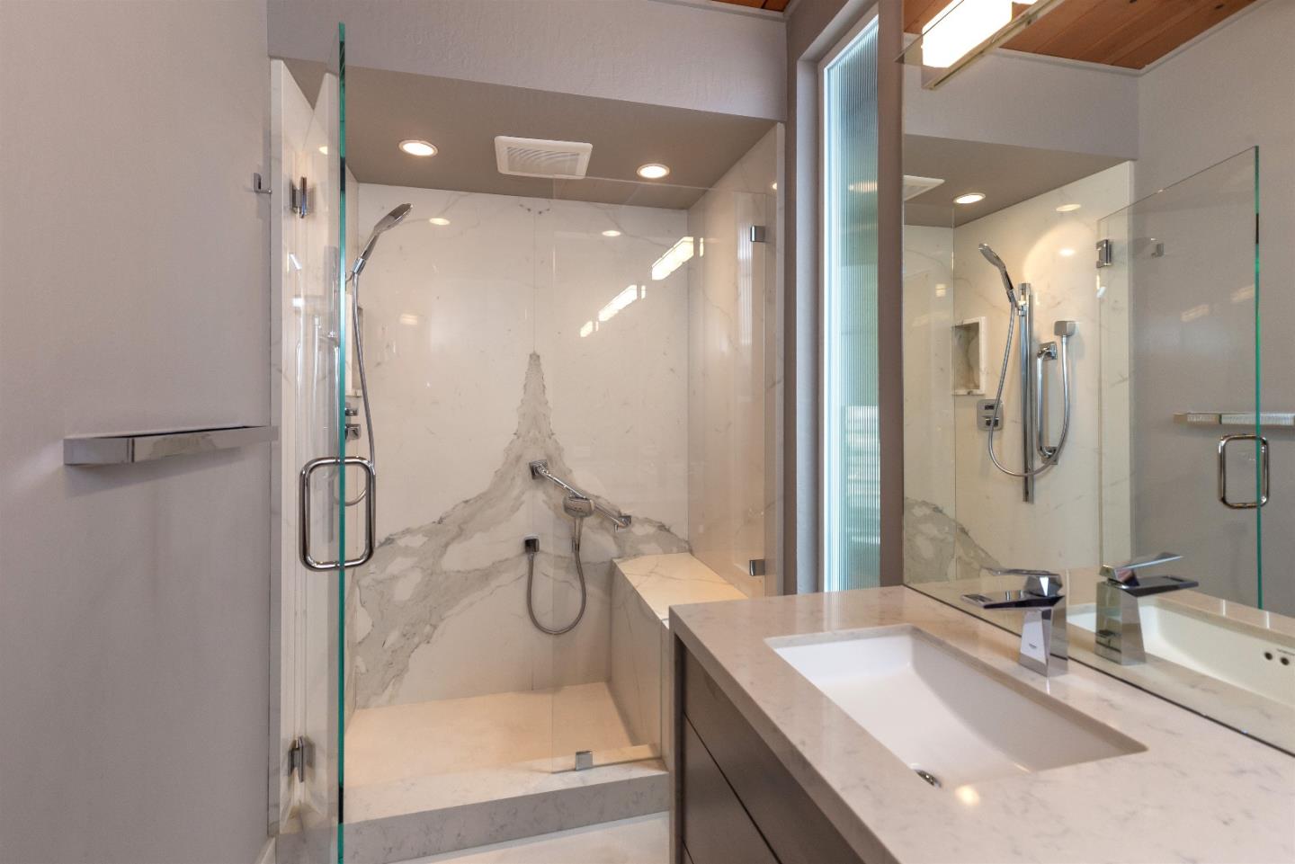 21661 Woolaroc Drive Los Gatos, CA 95033 - Photo 18 of 48 a bathroom with a granite countertop sink mirror and a shower