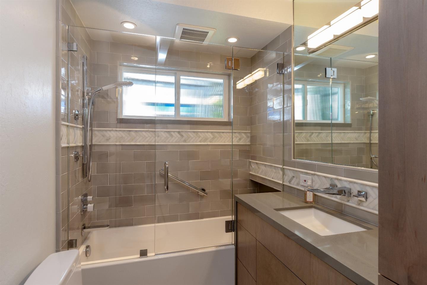 21661 Woolaroc Drive Los Gatos, CA 95033 - Photo 19 of 48 a bathroom with a granite countertop sink mirror and bathtub