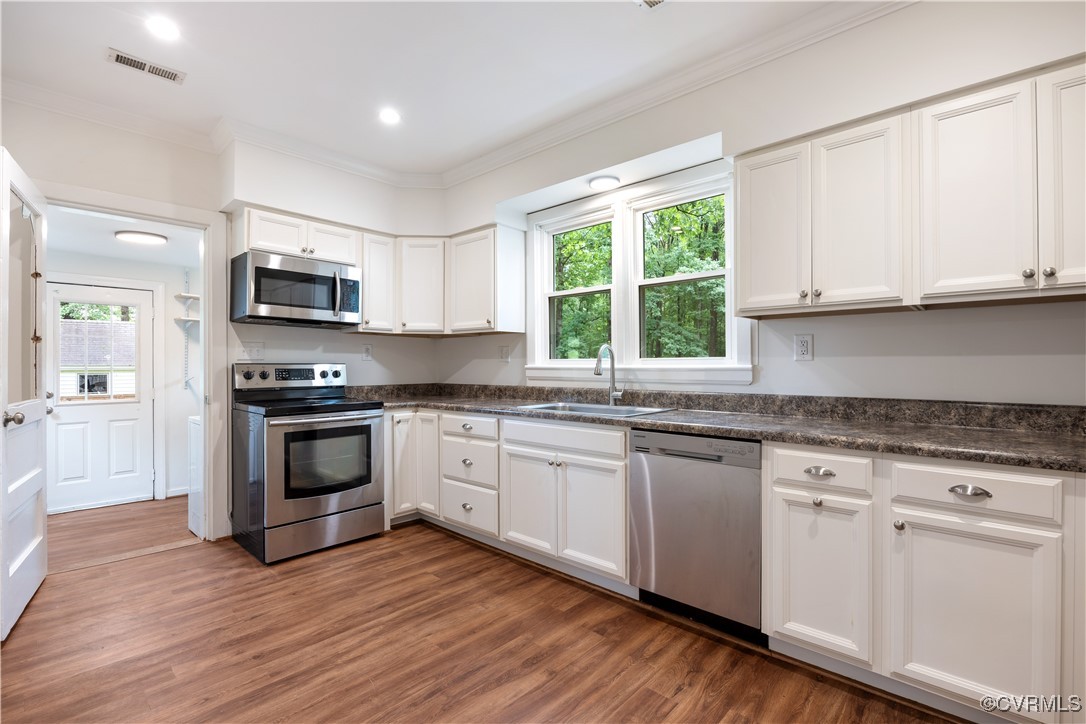 4593 Tabscott Road Columbia, VA 23038 - Photo 6 of 24 a kitchen with granite countertop white cabinets and appliances
