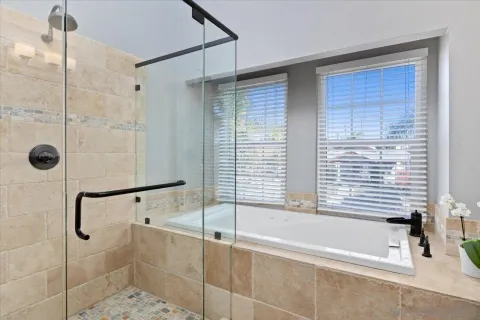 a bathroom with a bathtub and shower