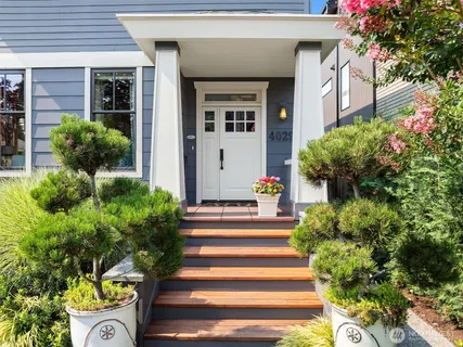 a front view of a house with plants