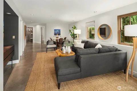 a bedroom with furniture and a large window