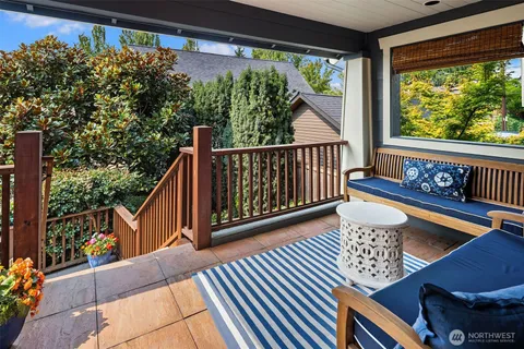 a view of a patio with furniture and wooden floor