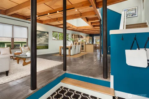 a living room with furniture a clock and a window