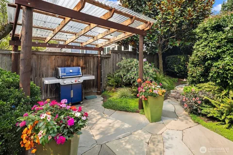 aerial view of a house with a yard and potted plants