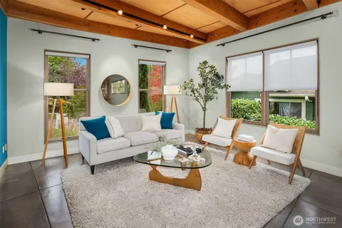 a living room with furniture a rug and a chandelier