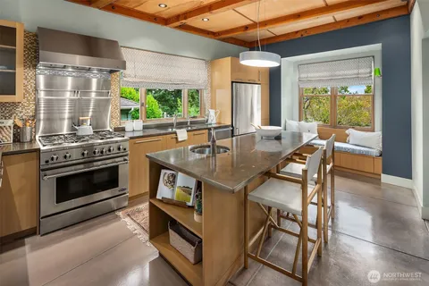 a kitchen with a table chairs and wooden floor