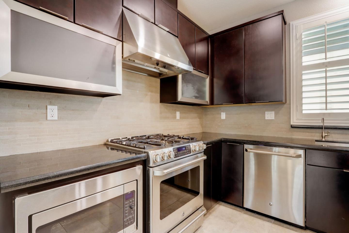 706 Ave One Drive San Jose, CA 95123 - Photo 12 of 60 a kitchen with stainless steel appliances granite countertop a stove and a microwave